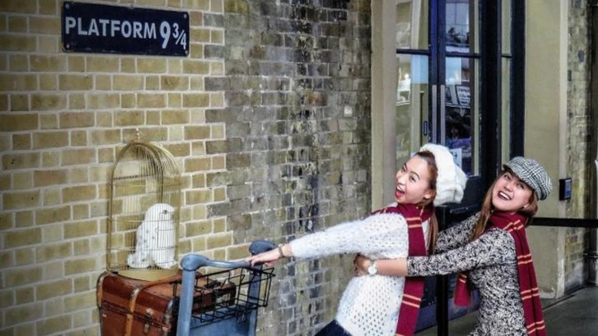 Sisters having fun at Platform 9 ¾ set at the Warner Bros studio in London